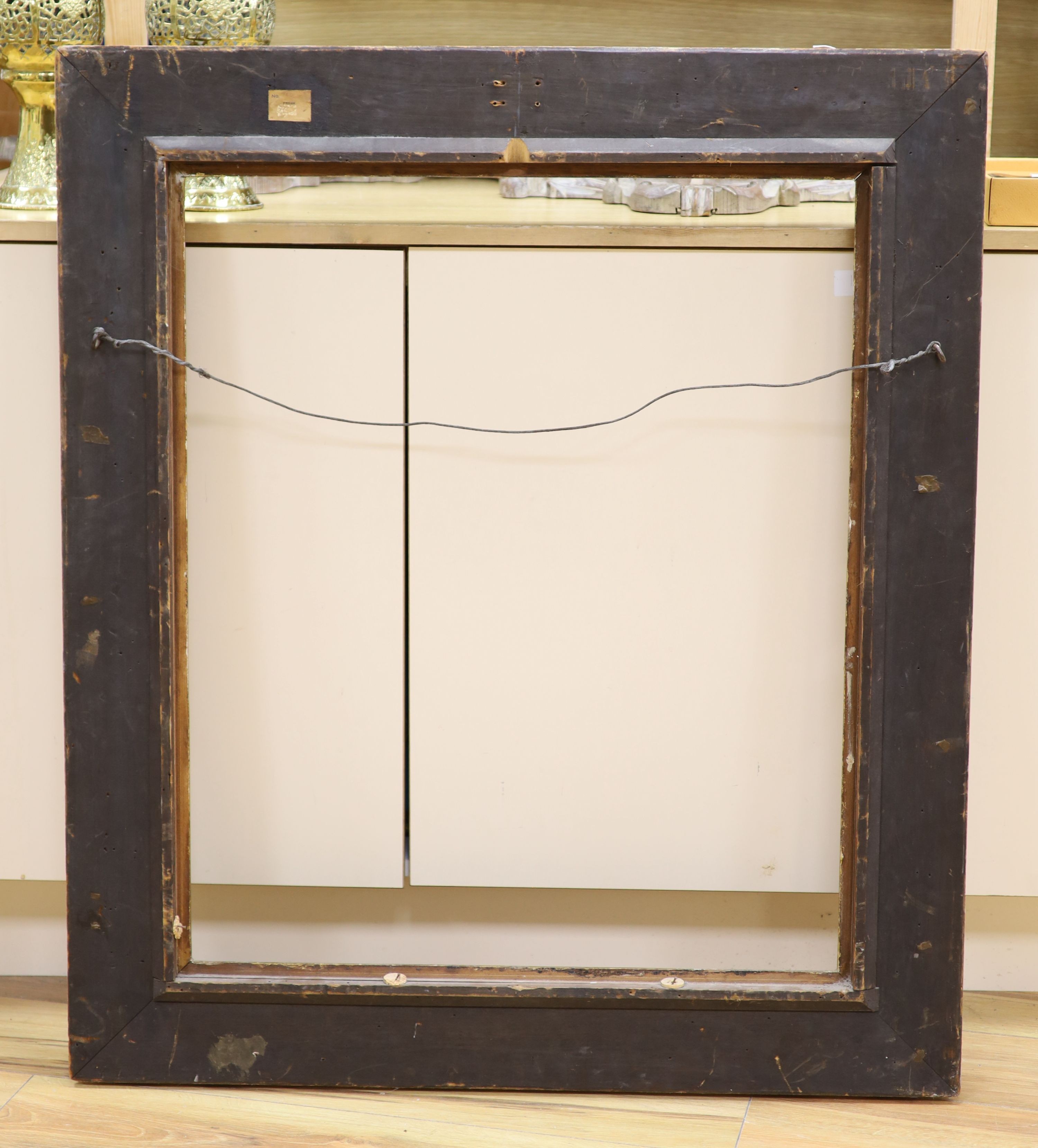 A 20th century carved giltwood scroll picture frame, aperture 78 x 63cm overall 100 x 86cm